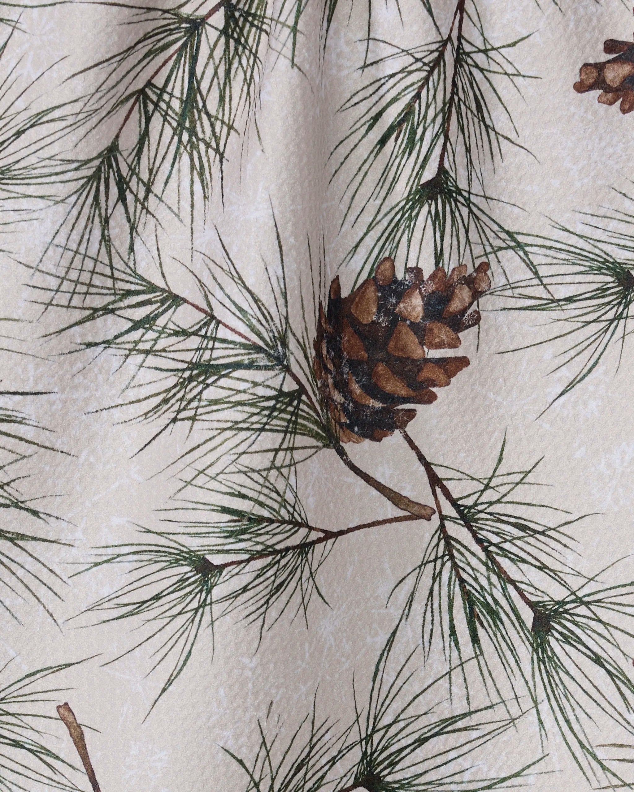 Evergreen Frost by Geometry features pine needles and cones on light beige. This eco-friendly kitchen towel adds a nature-inspired accent to your botanical fabric collection.