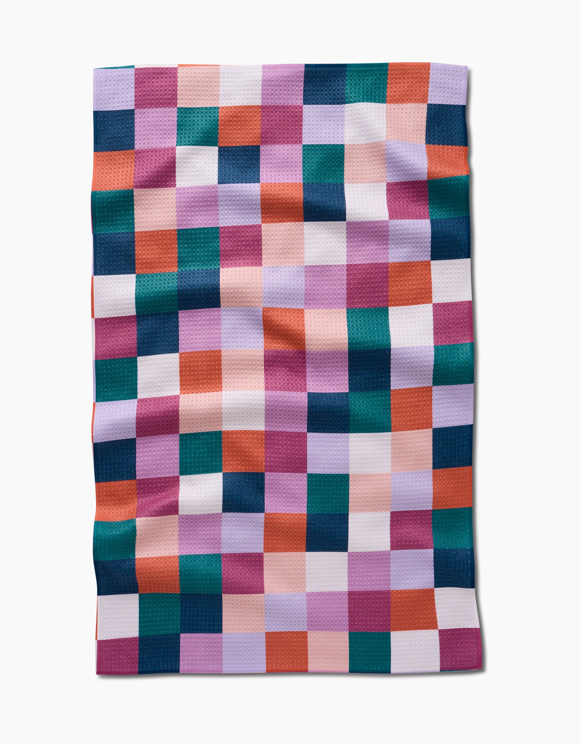 Fall Checkers by Claire Iglesias is a rectangular quilt with a checkerboard grid of teal, orange, pink, purple, and white squares. Crafted from textured Geoweave fabric with visible folds for added depth.