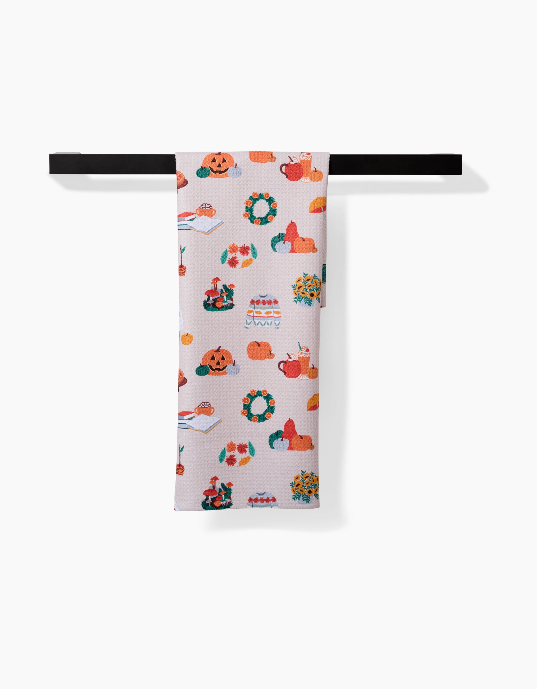 The Fall Favorites tea towel by Ceyda Alasar features vibrant Thanksgiving motifs—pumpkins, pies, turkeys, wreaths, and autumn leaves—on white. Quick-drying, it brings festive charm to your kitchen décor.