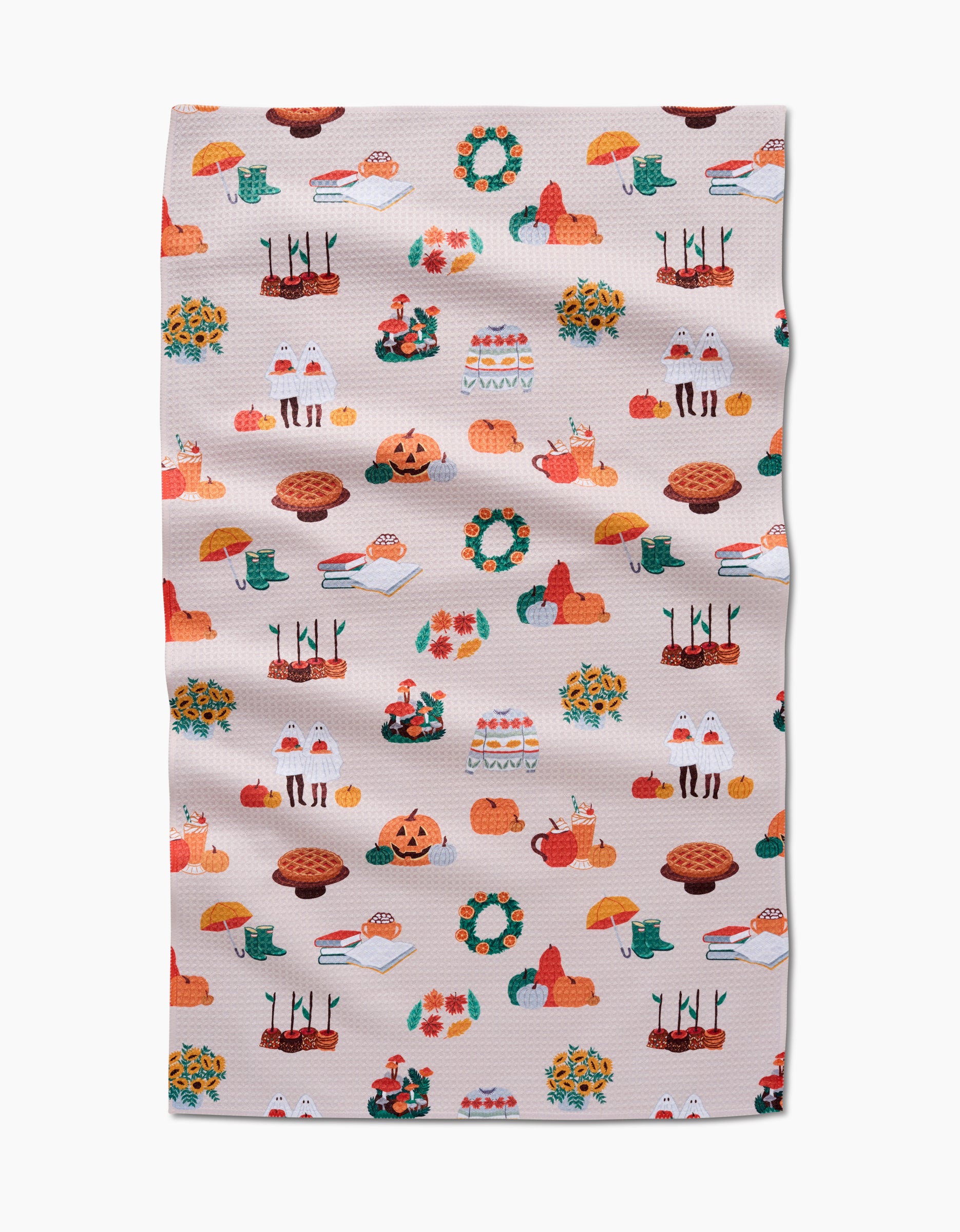 Add seasonal charm to your kitchen with Ceyda Alasar’s “Fall Favorites” tea towel—a beige recycled towel adorned with pumpkins, pies, leaves, mushrooms, and cozy autumn designs. Its slight wrinkle adds character to your fall decor.