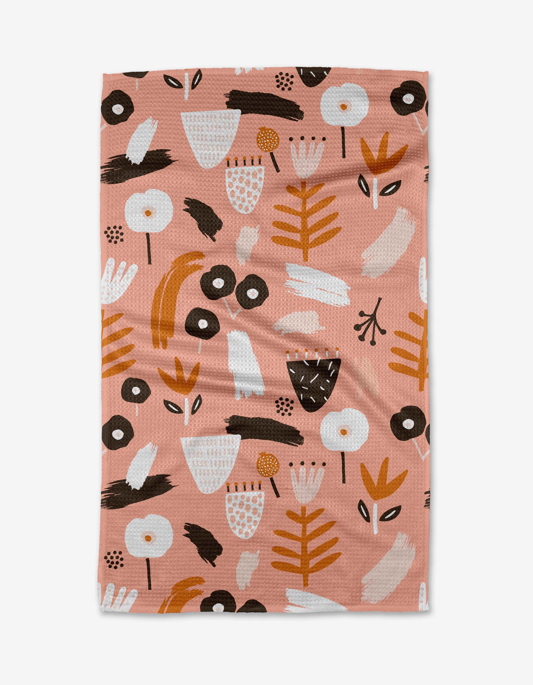 The Fall Flowerbed Swedish dishcloth by Marina Solodka features an abstract floral and leaf design in white, brown, gold, and black on pink Geoweave fabric, shown flat against a white background.