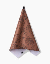 The Aubrey Fairchild Fall Foliage kitchen towel features a brown eco-friendly design with black leaf and acorn prints, a textured surface, white underside, and hangs from a black loop.
