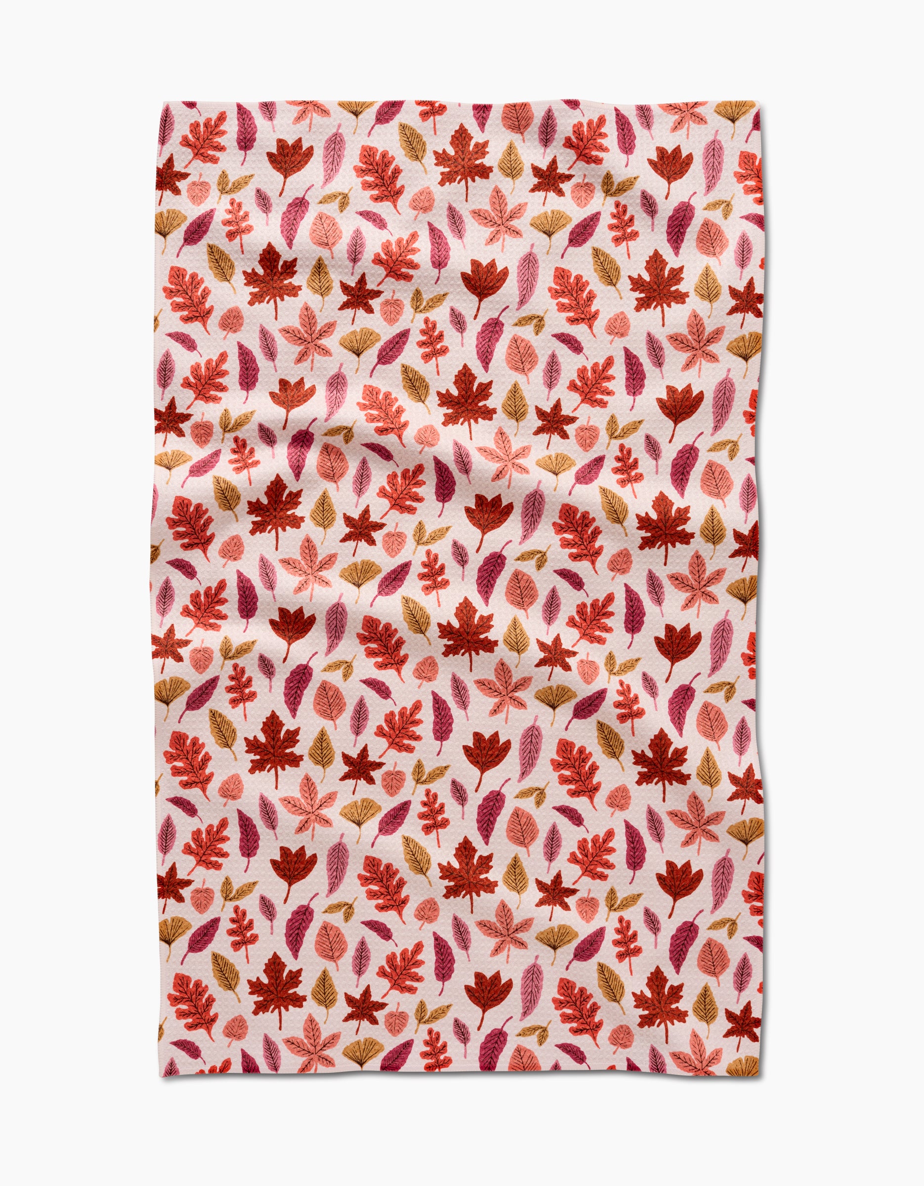 The Fall Leaves tea towel by Kayla Ann features a red, orange, and brown autumn leaf pattern on white. This absorbent, slightly wrinkled cloth is perfect for adding eco-friendly charm to your kitchen décor.