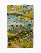 Fall Sunflower Cottage by Ceyda Alasar depicts a countryside with autumn trees, rolling hills, roads, and sheep on textured fabric—ideal for an eco-friendly tea towel made from recycled materials.