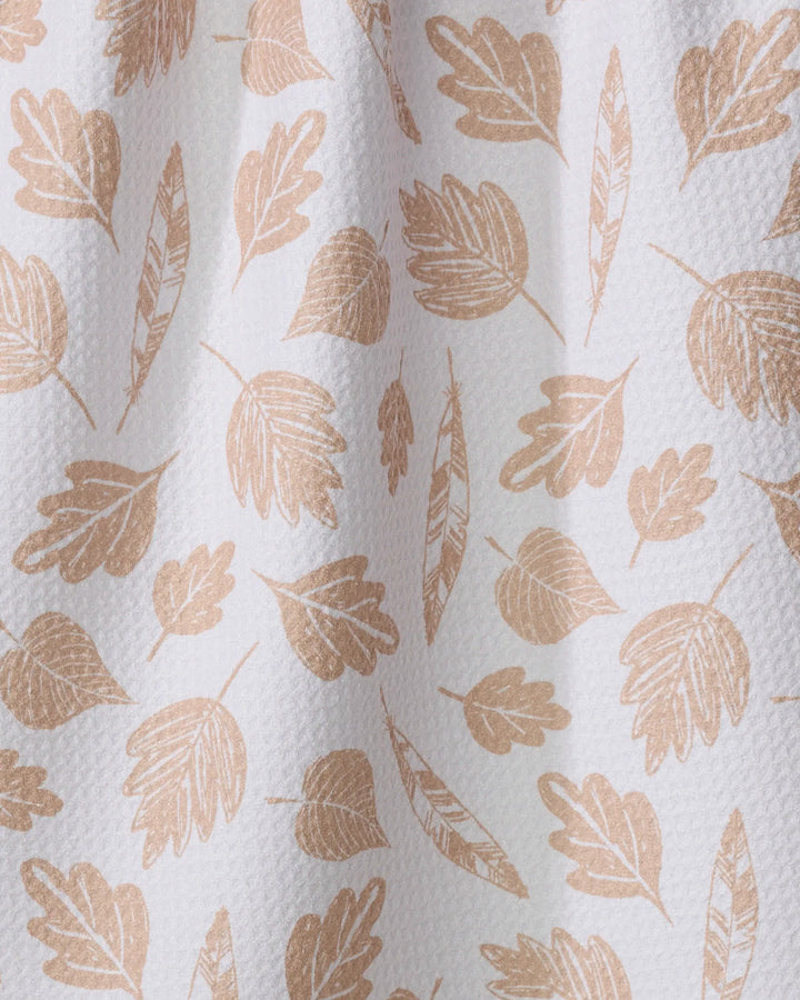 The Fallen Leaf tea towel by Hufton Studio is a textured, eco-friendly white towel with a simple light brown leaf-and-feather design. Slightly gathered, it brings natural charm and practical style to your kitchen.