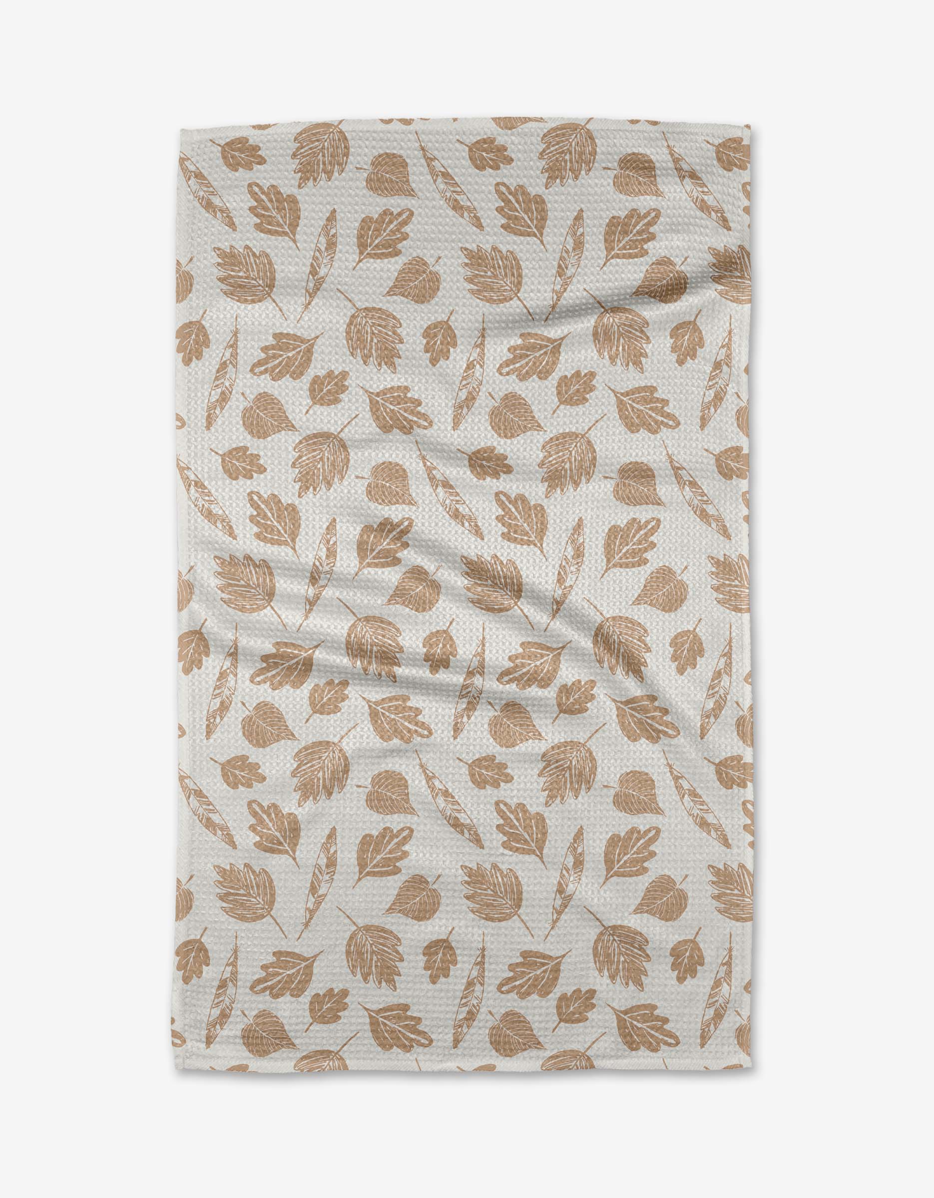 The Fallen Leaf Tea Towel by Hufton Studio features brown autumn leaves and acorns on white Geoweave™ fabric, shown slightly wrinkled and laid flat on a white background.