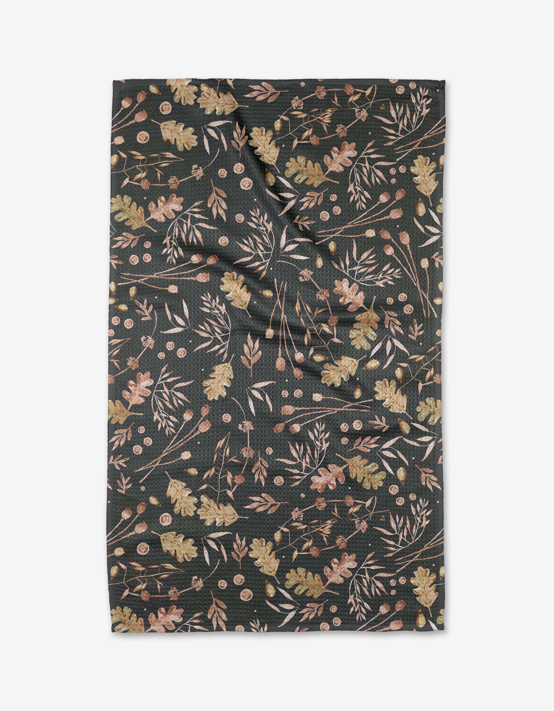 The Fallen Oak by Katie OShea features a dark Geoweave fabric with leaves, berries, and branches in muted browns, greens, and golds. Eco-friendly and crafted from recycled materials, its shown flat with subtle wrinkles.