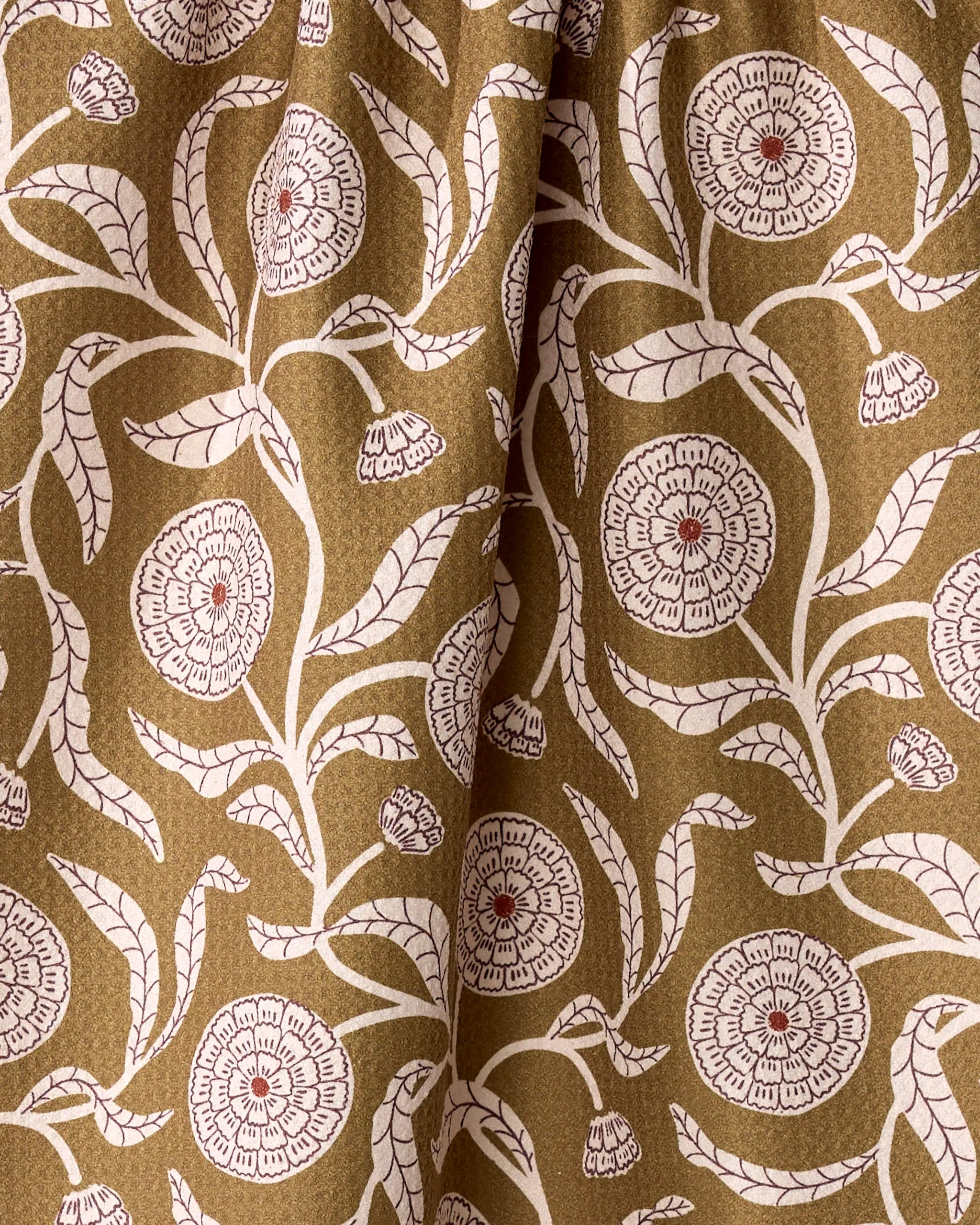 The Falling Flowers dish towel by Teri the Butter features brown fabric with a vintage-inspired white floral pattern, red-centered blooms, and textured folds—an absorbent towel perfect for display or daily use.