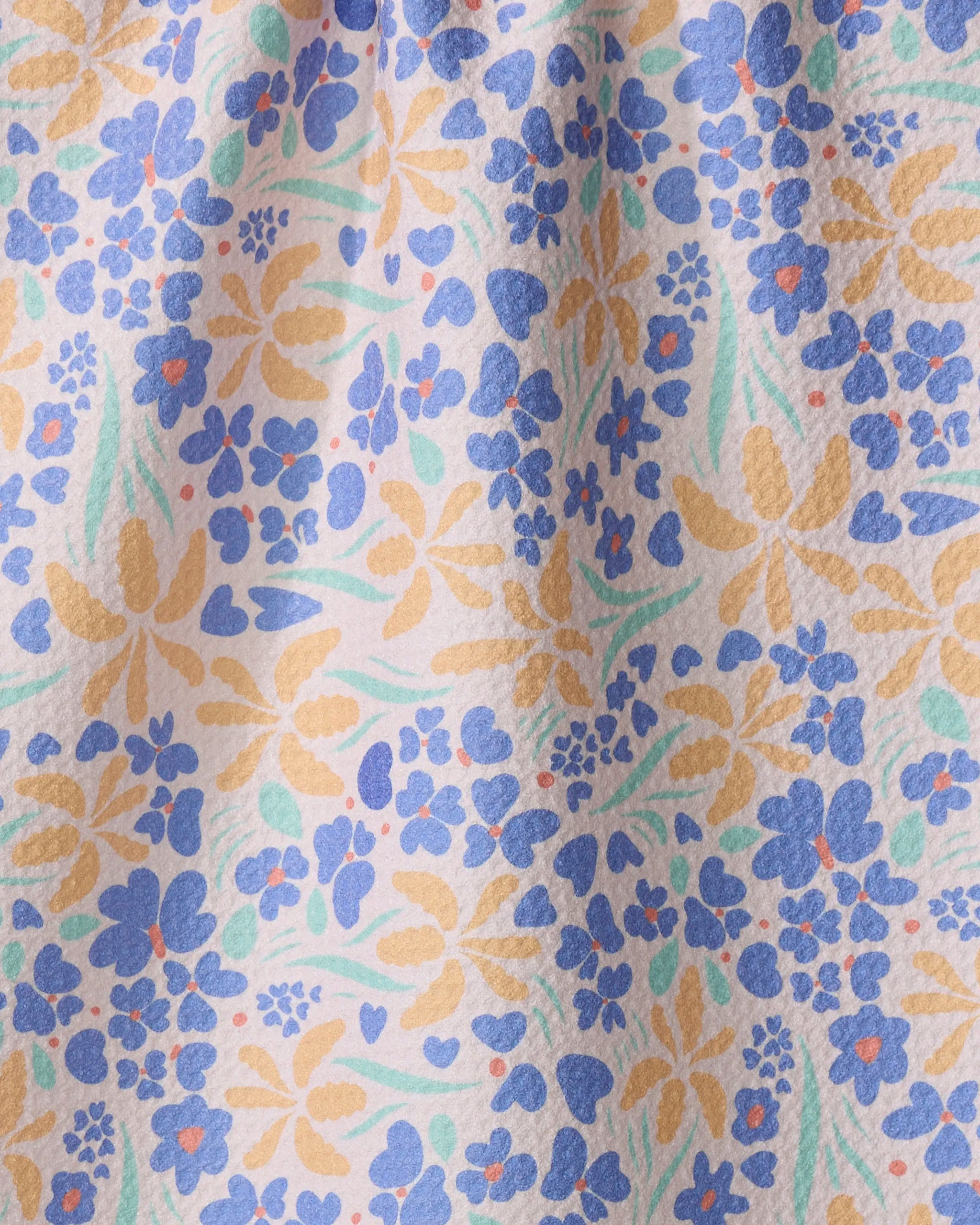 A close-up of Elisabeth Wing's "February" eco-friendly kitchen towel, showing a white background with yellow, blue, and orange flowers and green leaves. The absorbent dish towel appears slightly wrinkled.