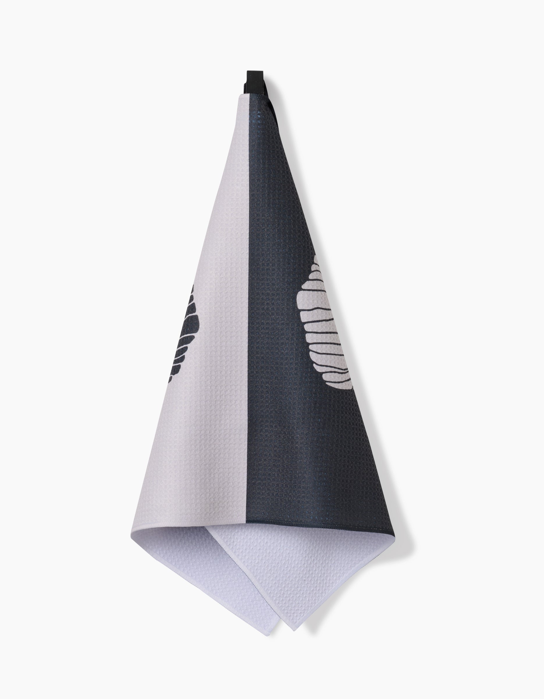 The Anna Christian Fika is a two-toned Geoweave™ kitchen tea towel, half light gray and half dark gray, each side with a partial white and black striped oval. Made from recycled materials. Displayed against a white background.