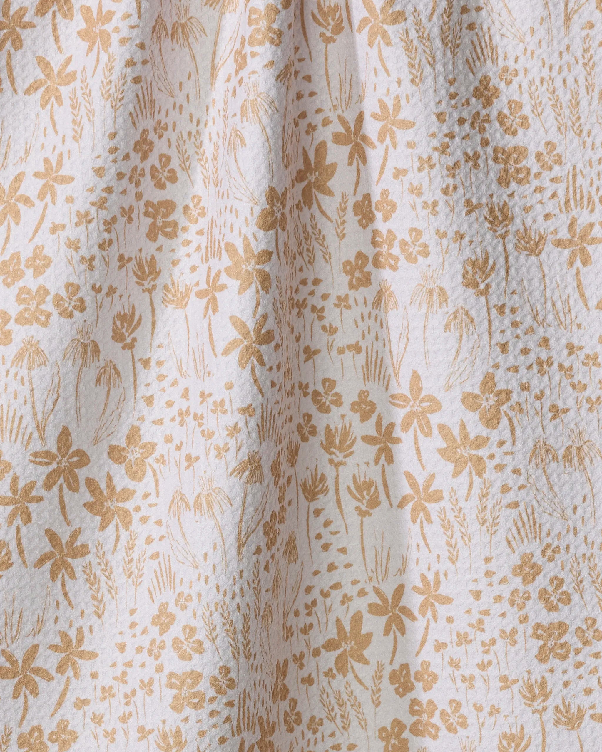 Close-up of Hufton Studio’s Floating Meadow: a white recycled kitchen towel featuring a delicate, natural pattern of light brown hand-drawn flowers and leaves for a whimsical touch.