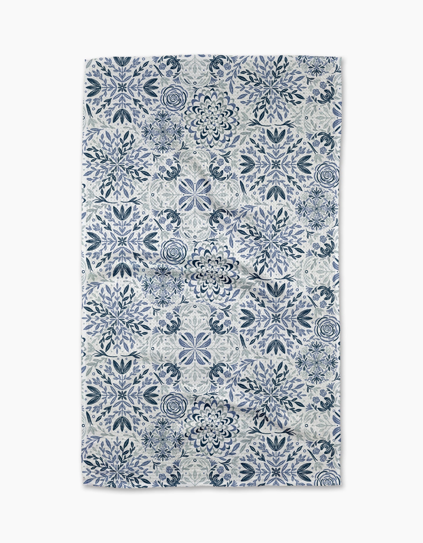 The Floral Medallions tea towel by Sarah Daugherty features a symmetrical blue and white floral and geometric tile-inspired pattern on a crisp white background.