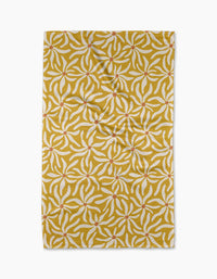 The Floral Spell rug by Gerdadzy is rectangular and yellow, featuring white and orange abstract leaf patterns. Photographed from above on a white background, it has slight creases and resembles a quick-drying tea towel.