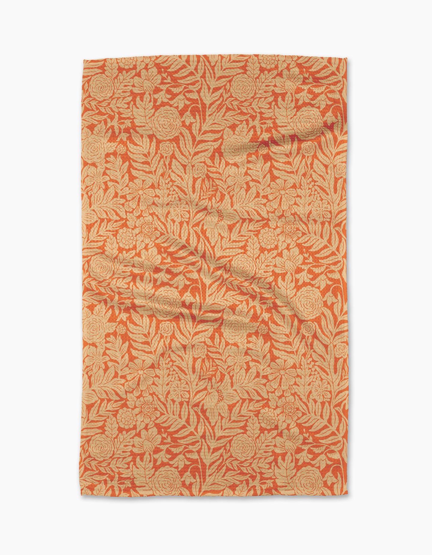 The Florence tea towel by Katie OShea is rectangular and features an intricate orange and beige floral pattern with leaves and flowers covering the entire surface.