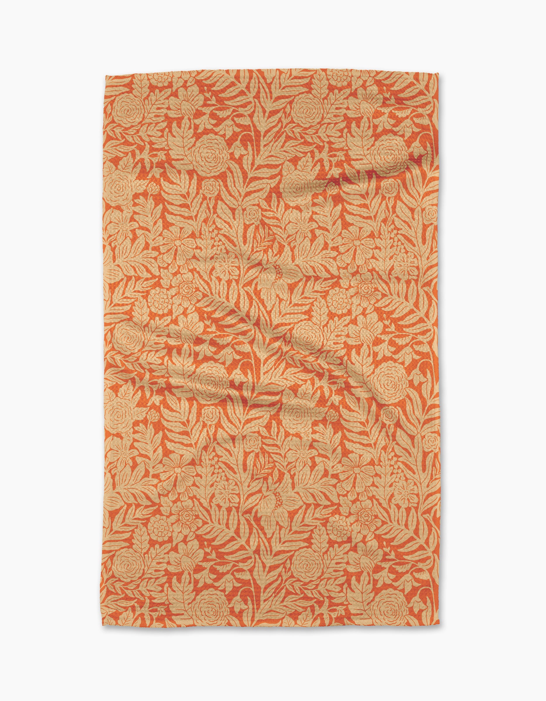 The Florence tea towel by Katie OShea is rectangular and features an intricate orange and beige floral pattern with leaves and flowers covering the entire surface.