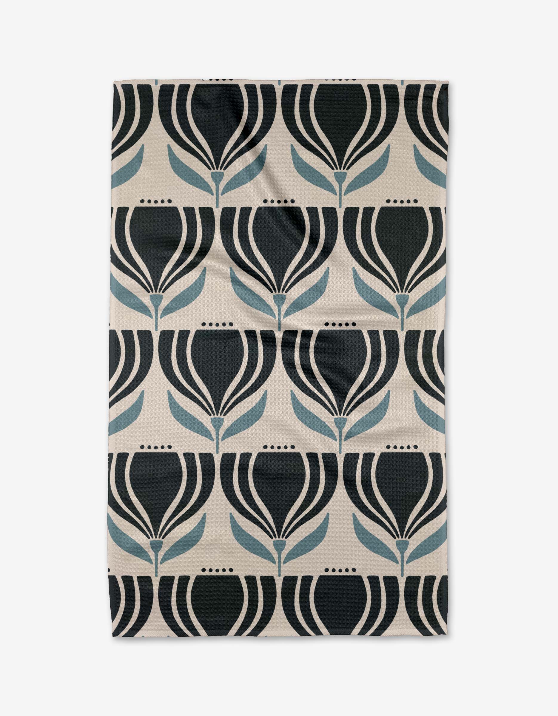 The “Florian” tea towel by Amy MacCready features a repeating geometric pattern of stylized black and blue tulip-like flowers on beige, made from recycled materials for a modern, symmetrical look.