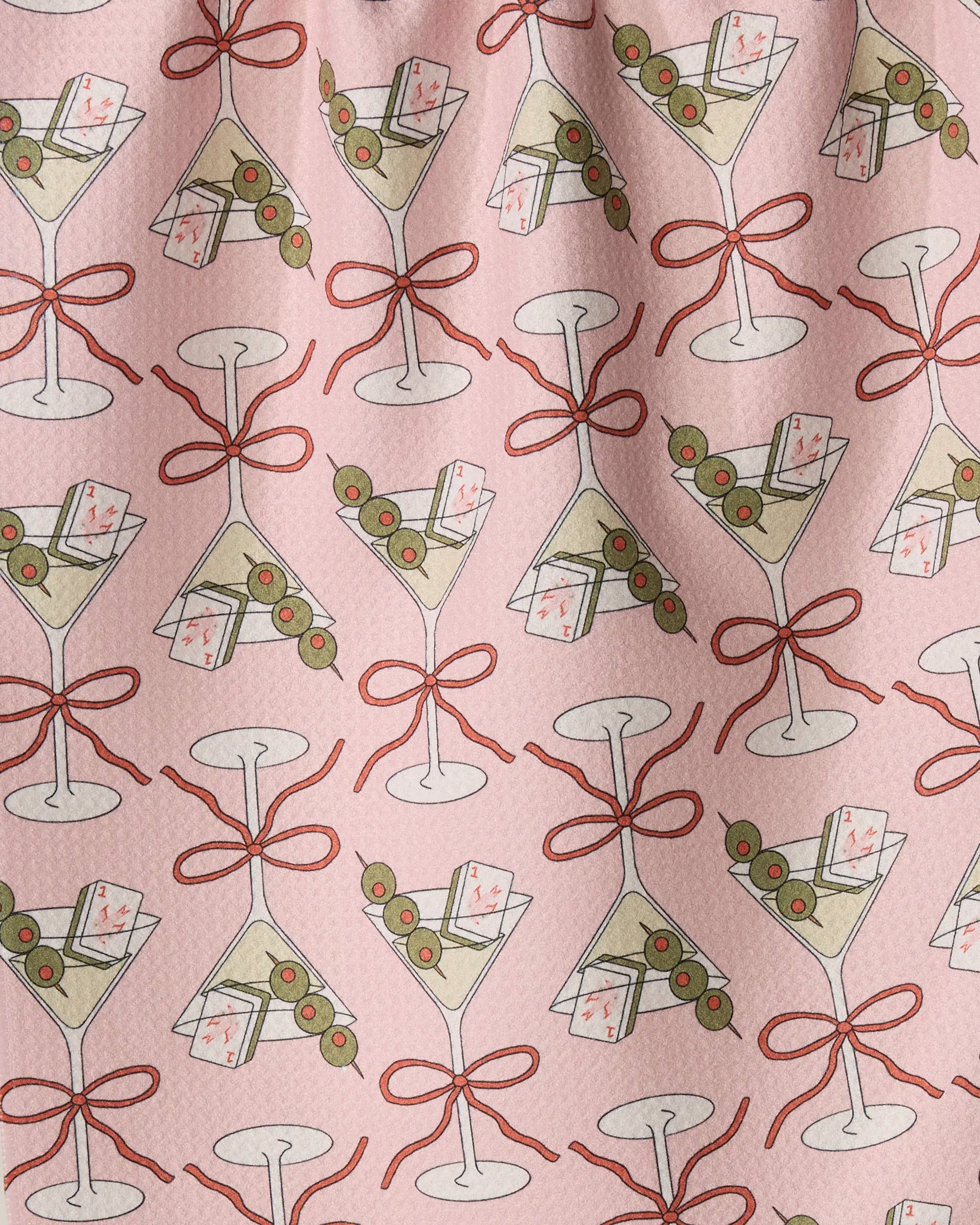 Flower-tinis by Geometry features a playful, festive patterned fabric adorned with martini glasses filled with olives and cocktail napkins, each glass tied with a red bow. Outlined in red on a pink background, this design adds both style and functionality to your kitchen décor—making it the perfect choice for an absorbent tea towel or dish towel.