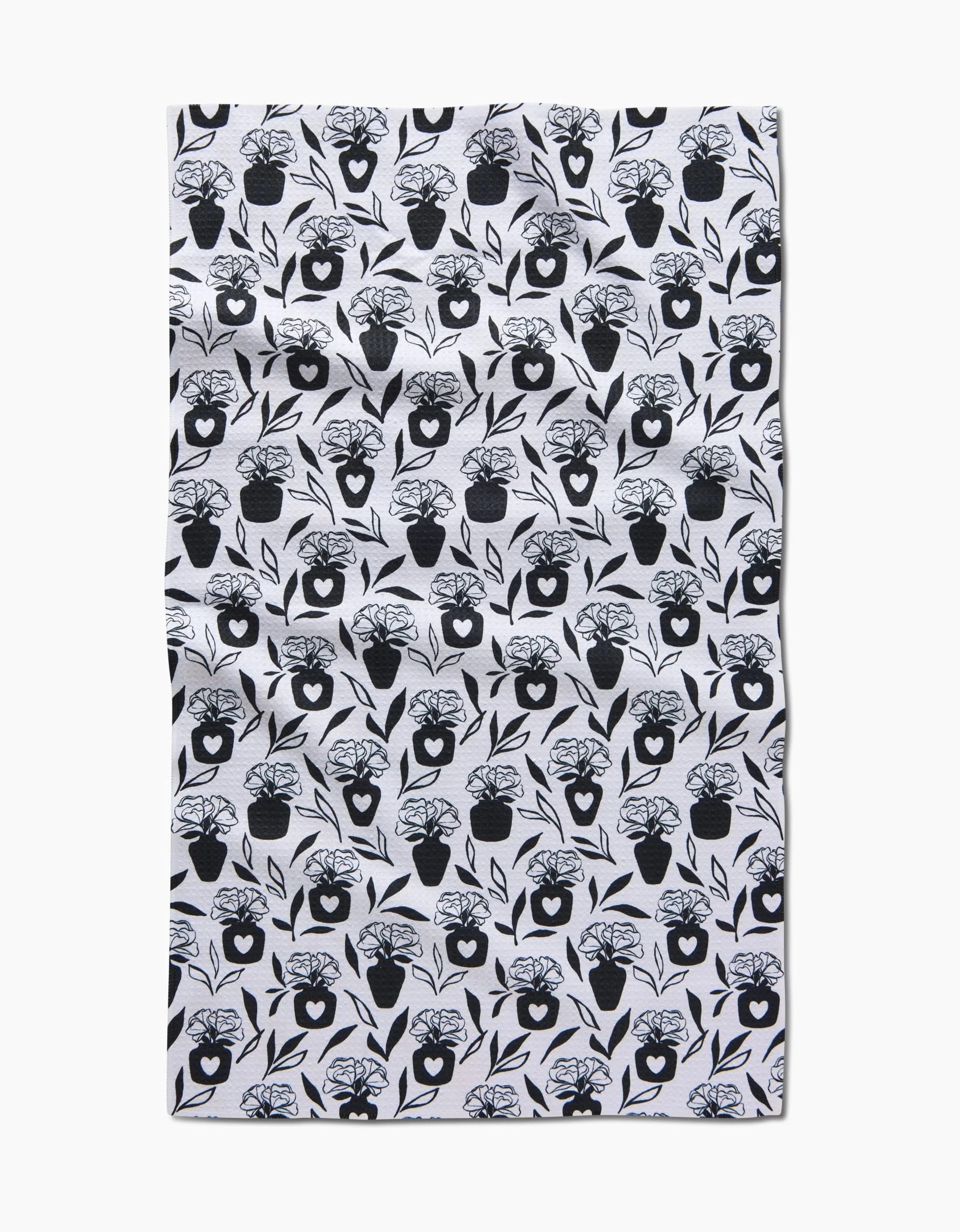 The Flowers for Me tea towel by Charlie Rowan Designs features a repeated black floral vase pattern on white, made from quick-drying fabric with a slightly wrinkled look, photographed on a plain white background.