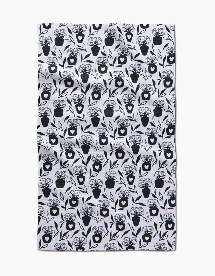 The Flowers for Me tea towel by Charlie Rowan Designs features a repeated black floral vase pattern on white, made from quick-drying fabric with a slightly wrinkled look, photographed on a plain white background.