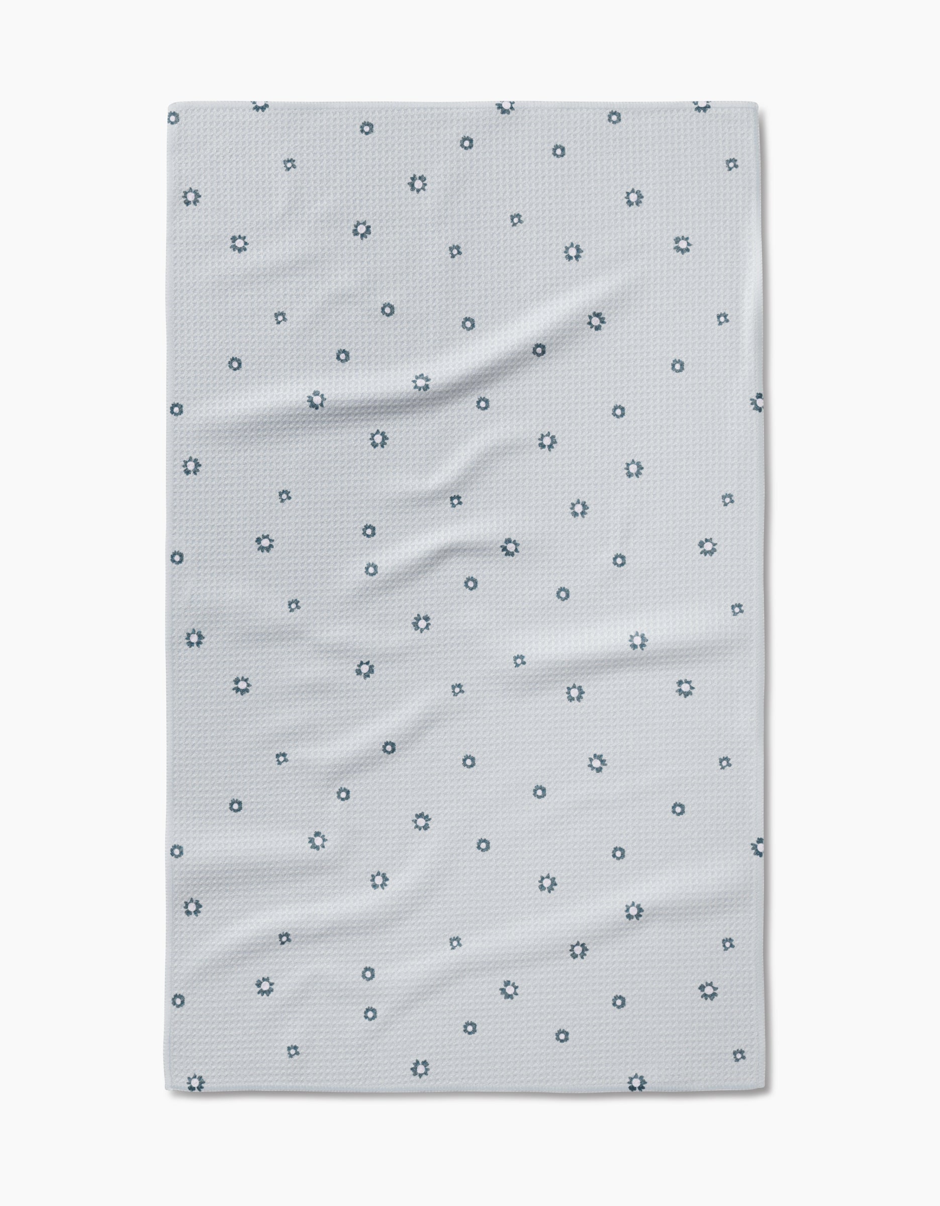 The Forest Daisy Tea Towel by Coit Creative features a light gray design with dark blue outlined circles and stars on soft, slightly wrinkled Geoweave™ fabric for enhanced durability and absorbency.