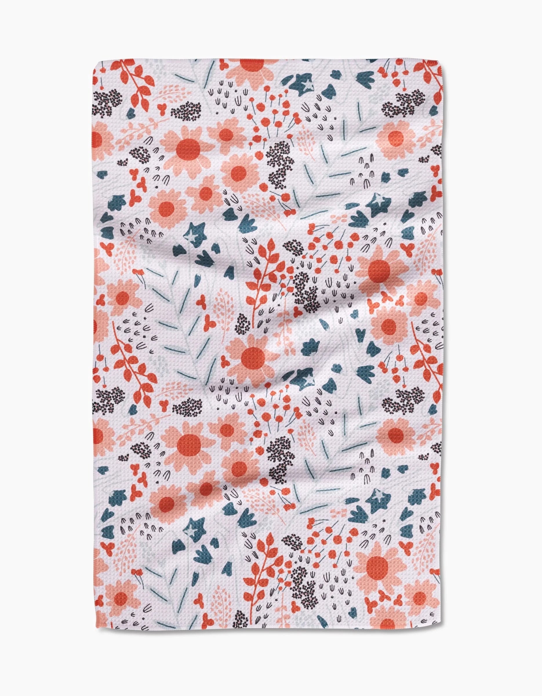 The Forest Foliage tea towel by Coit Creative features a colorful floral pattern with orange, red, and blue flowers and leafy branches on soft white Geoweave fabric.