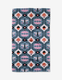 The Forest Garden towel by Anette Heiberg is ultra-absorbent and showcases whimsical mushrooms, dragonflies, and abstract florals in pink, red, black, and white on a blue background.