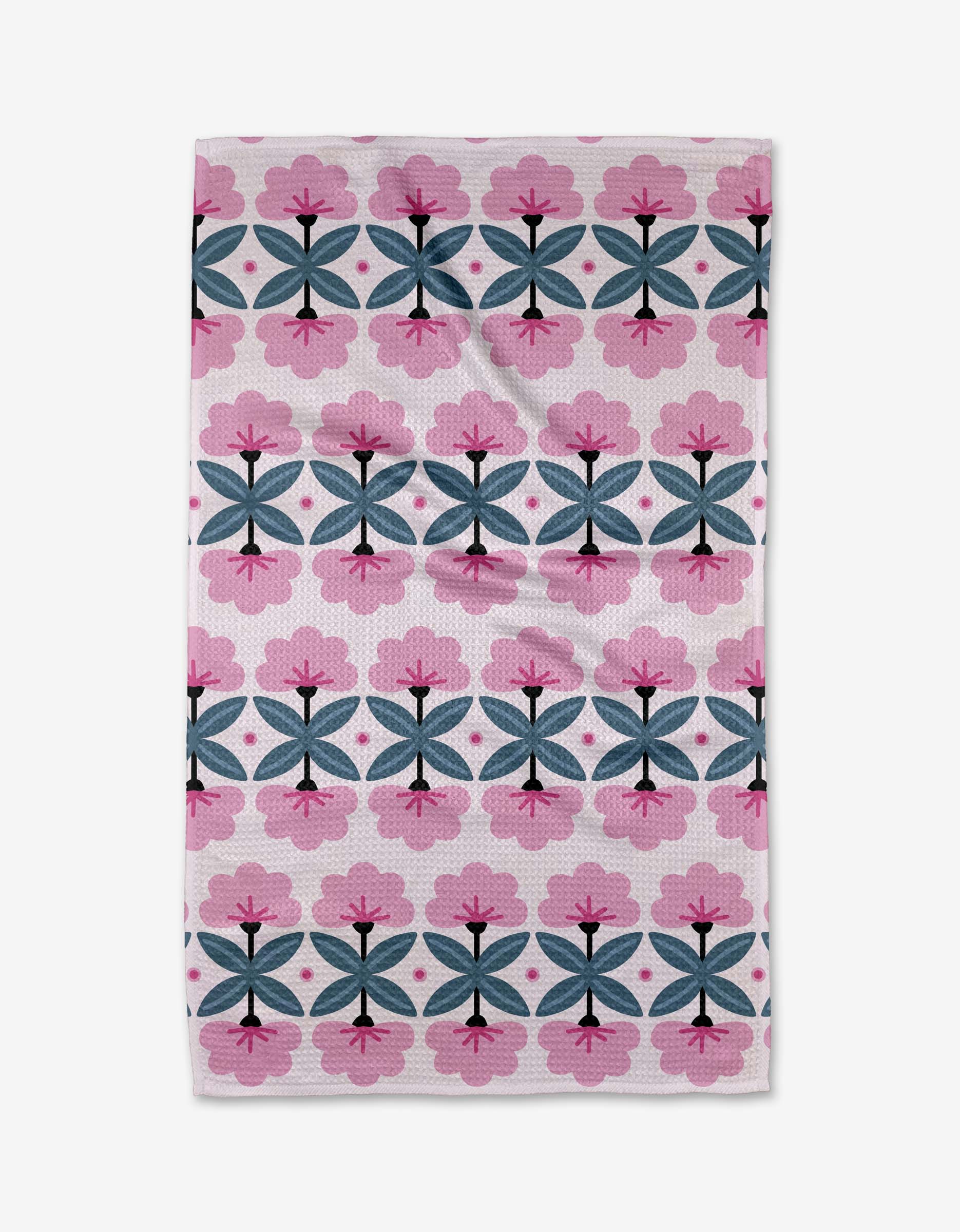 The Fragrant Flowers tea towel by Anette Heiberg is rectangular, ultra-absorbent, and made from recycled materials. Its white background displays a pink, black, and blue geometric floral design with a visibly textured surface.