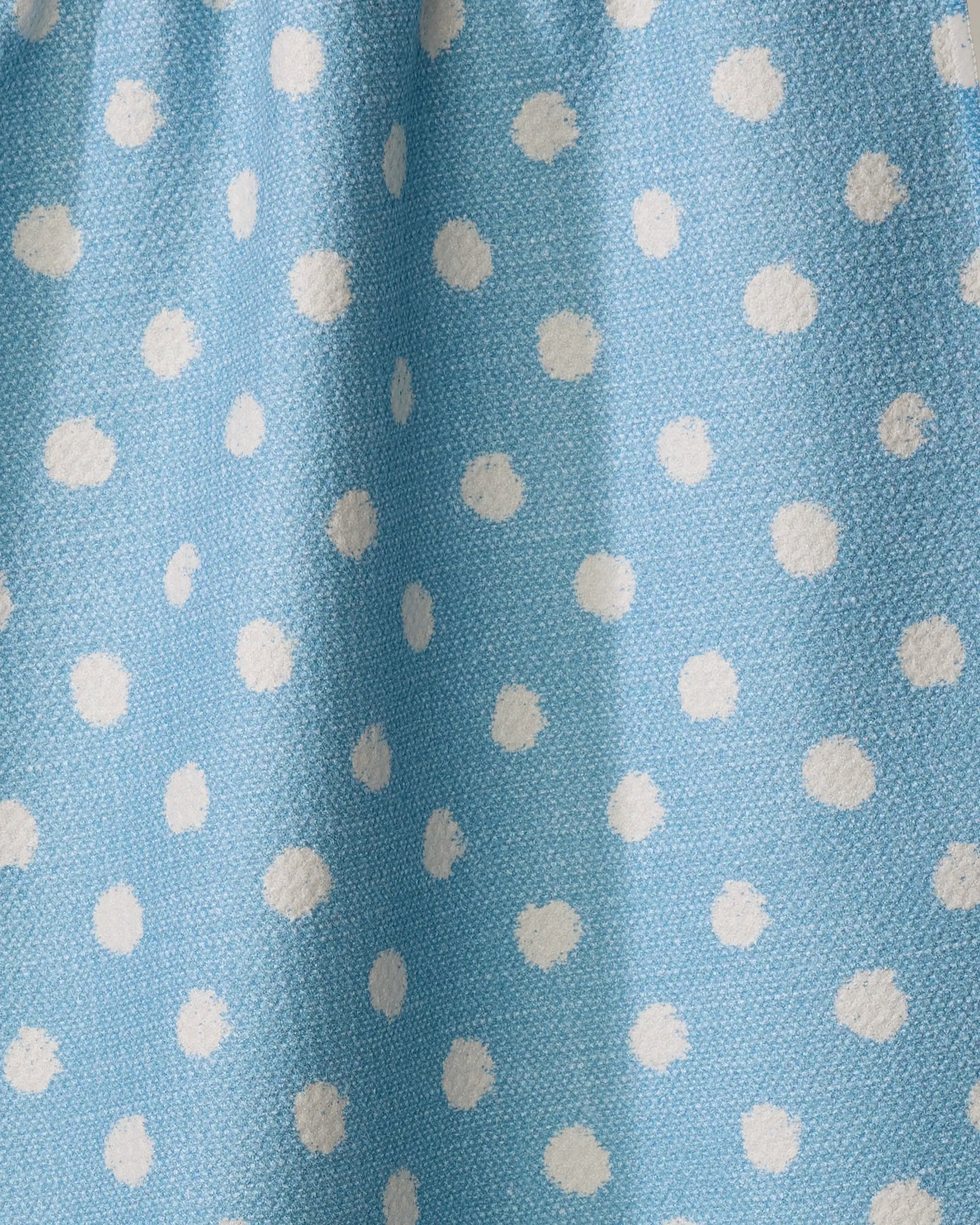 The Freckle Light Blue tea towel by Geometry features a visible texture and evenly spaced white polka dots, crafted from recycled materials.