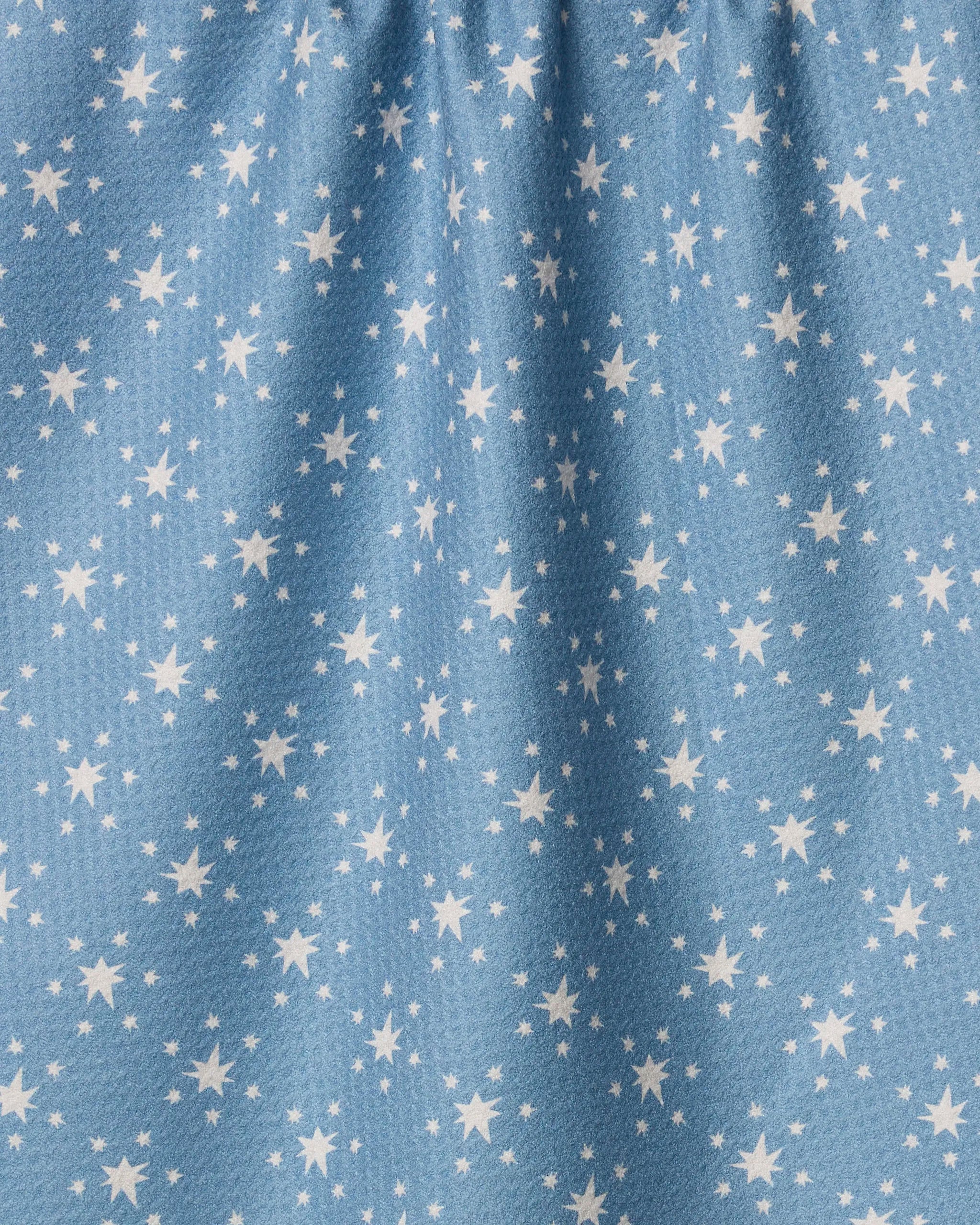The Freedom Blue towel by Geometry features ultra-absorbent blue fabric with small white stars, gathered at the top for subtle vertical folds and shadows.