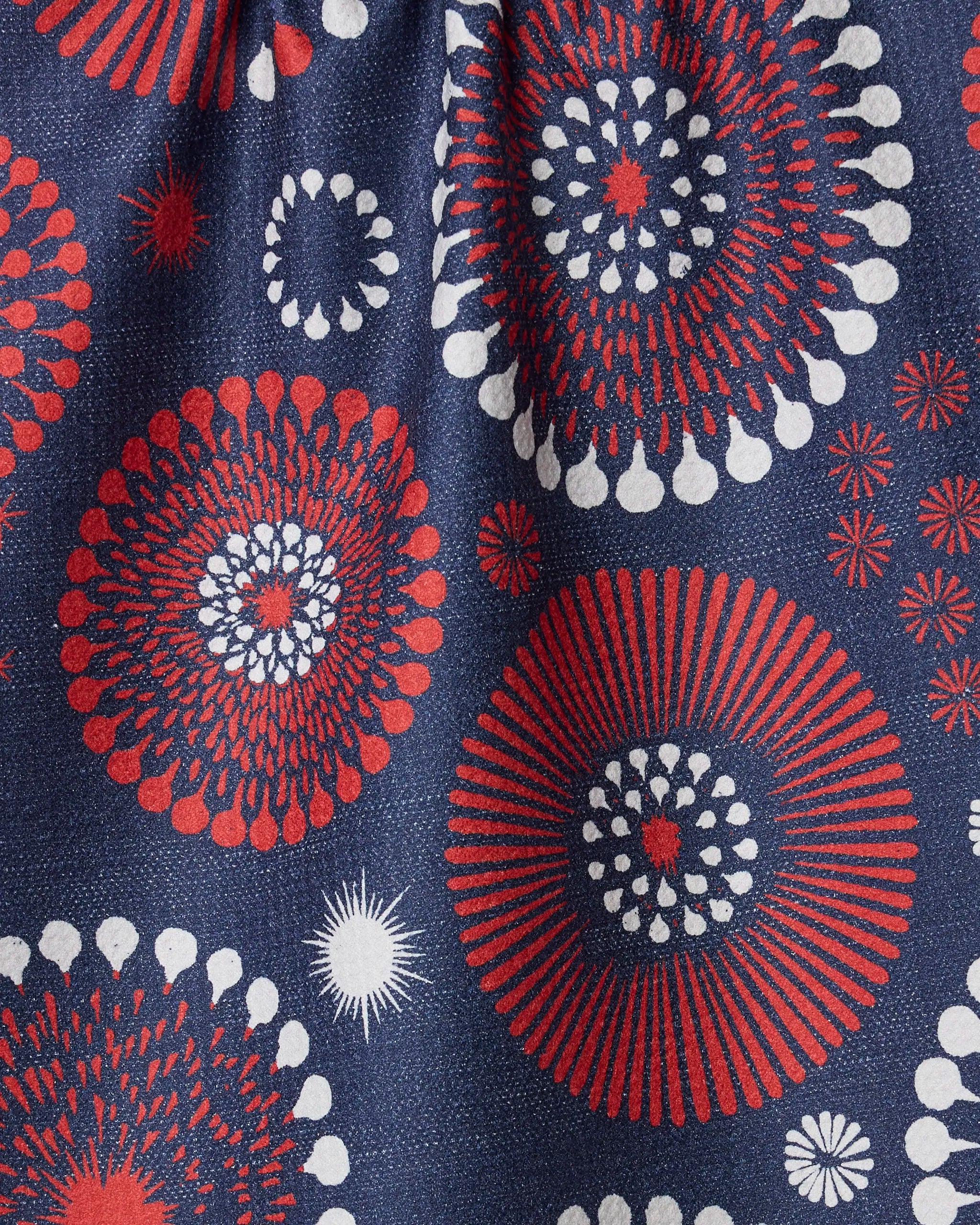 Geometry's "Freedom Sparks" recycled kitchen towel features red, white, and blue fireworks-inspired bursts and dots on a dark blue background.