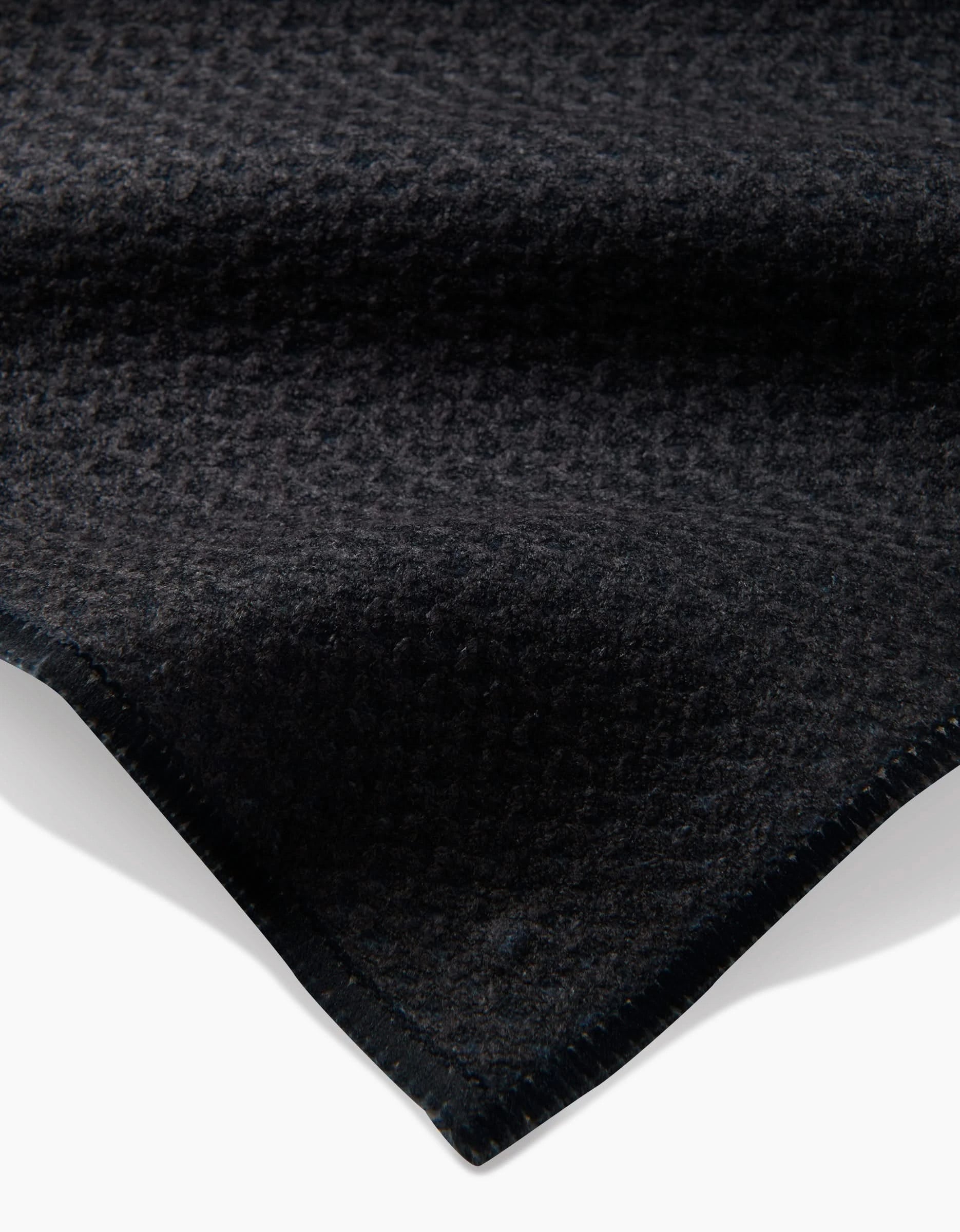 A close-up of the Freja by Anna Christian, featuring dark Geoweave fabric with a subtle houndstooth pattern and neatly stitched edges, shown against a white background.