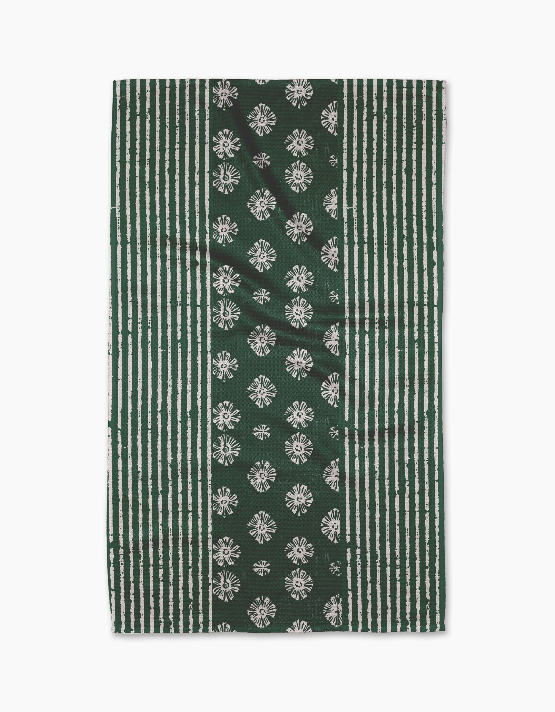 The Freya tea towel by Geometry features vertical green and white stripes with a central panel of white floral motifs on green, crafted from durable Geoweave fabric.