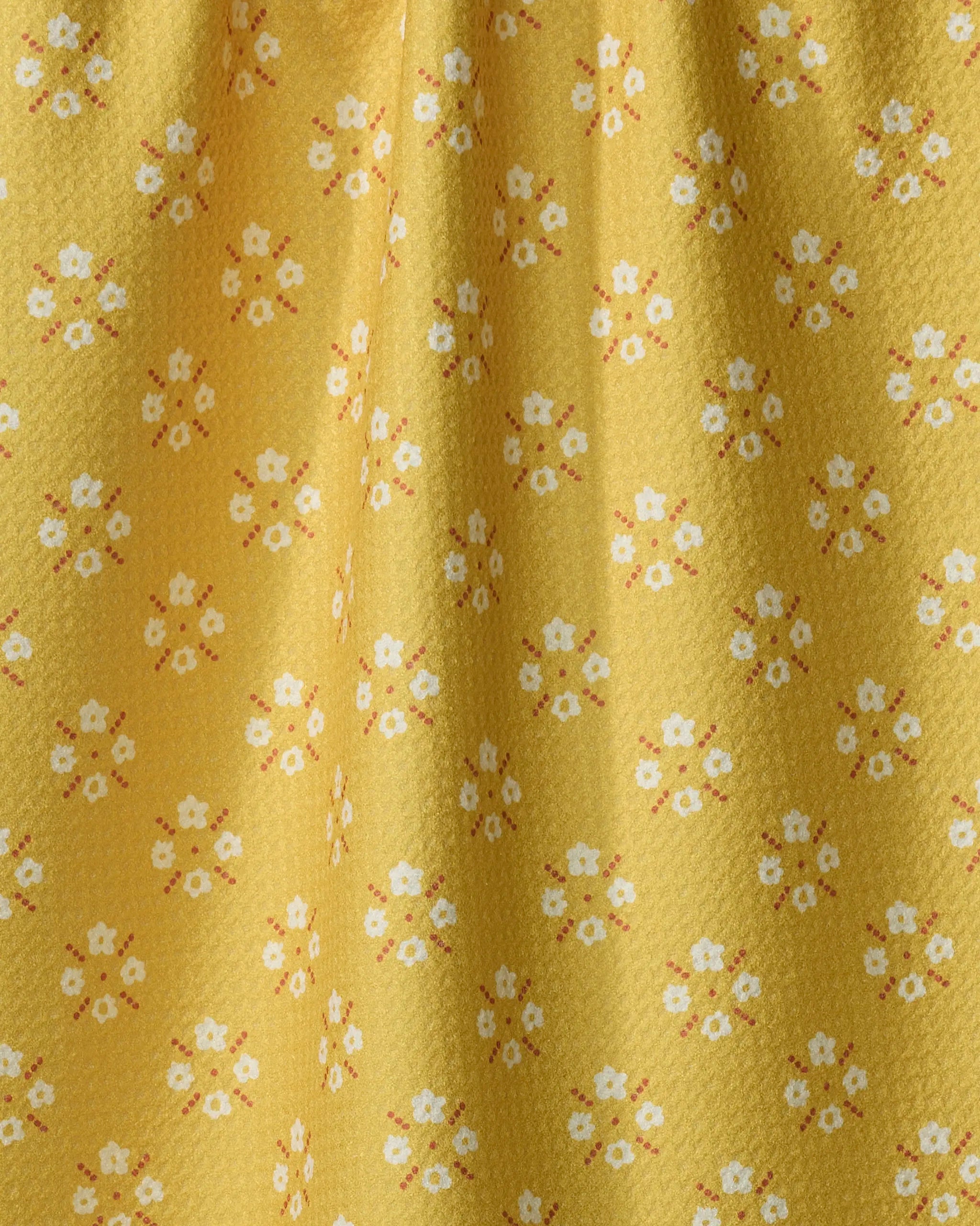 Garden Lattice by Kelsey Weigl features a yellow textured fabric made from recycled materials, adorned with white and orange floral patterns—ideal as a tea towel that drapes softly.