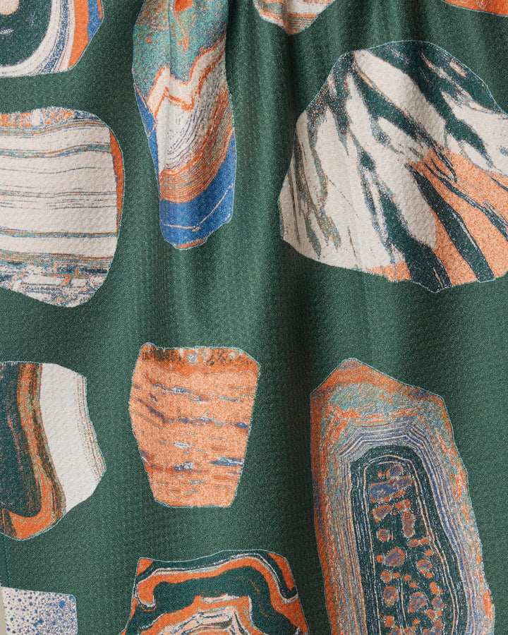 Close-up of the Geometry Geo Class recycled kitchen towel, featuring abstract multicolored shapes in orange, blue, white, and beige. This absorbent dish towel has a slightly textured surface and eco-friendly design.
