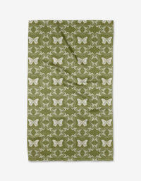 The Geometric Butterflies tea towel by Second Nature Studio features a green, rectangle shape with white butterfly and botanical patterns, made from recycled materials and shown flat on a white background.