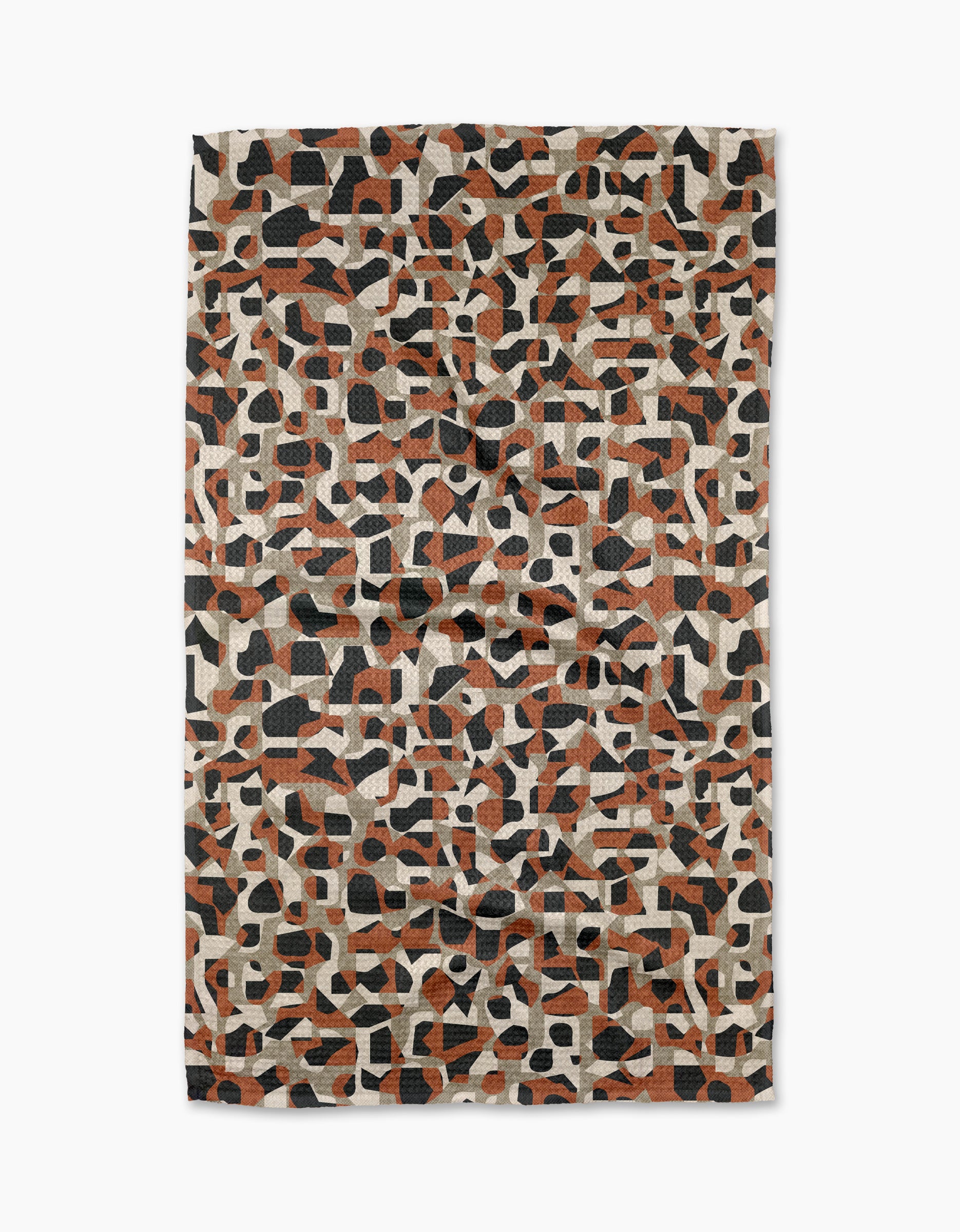 The Geometric Leopard tea towel by Kris Ruff features an abstract geometric pattern in black, orange, and cream, packed with irregular shapes for a textured, mosaic look—ideal for adding style to your kitchen.