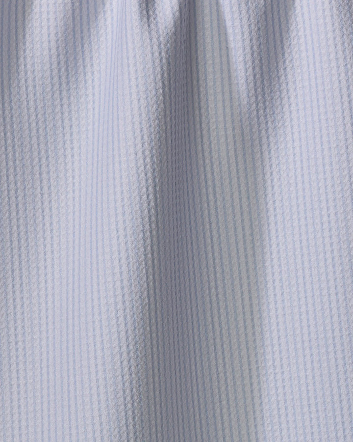 Close-up of The Buy Guide's Get In Line - Light Blue tea towel, featuring light blue and white vertical stripes. Its subtly textured, ultra-absorbent material makes it perfect for daily kitchen use.