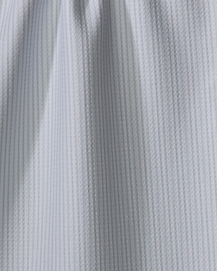 Close-up of The Buy Guide's Get In Line - Mint seersucker fabric, featuring mint and white thin vertical stripes, gentle folds, and a puckered texture often used for tea towels.
