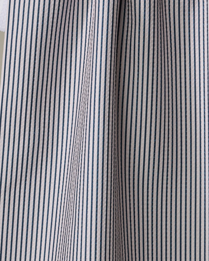 Close-up of The Buy Guide’s Get In Line - Navy towel, featuring blue and white vertical stripes. Ultra-absorbent fabric with soft folds and gentle shadows highlights its textured look.