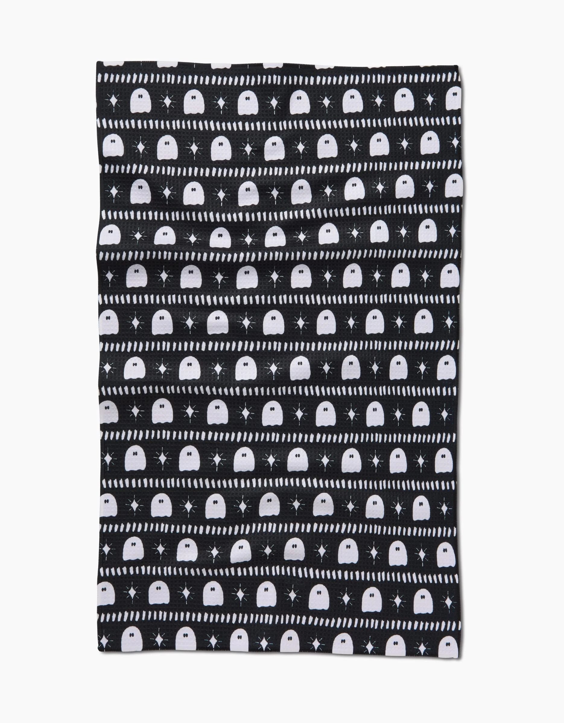 The Ghost Pac Tea Towel by Charlie Rowan Designs is a black rectangular towel made from recycled Geoweave™ fabric, featuring horizontal stripes of white ghosts, stars, and dots for sustainable style.