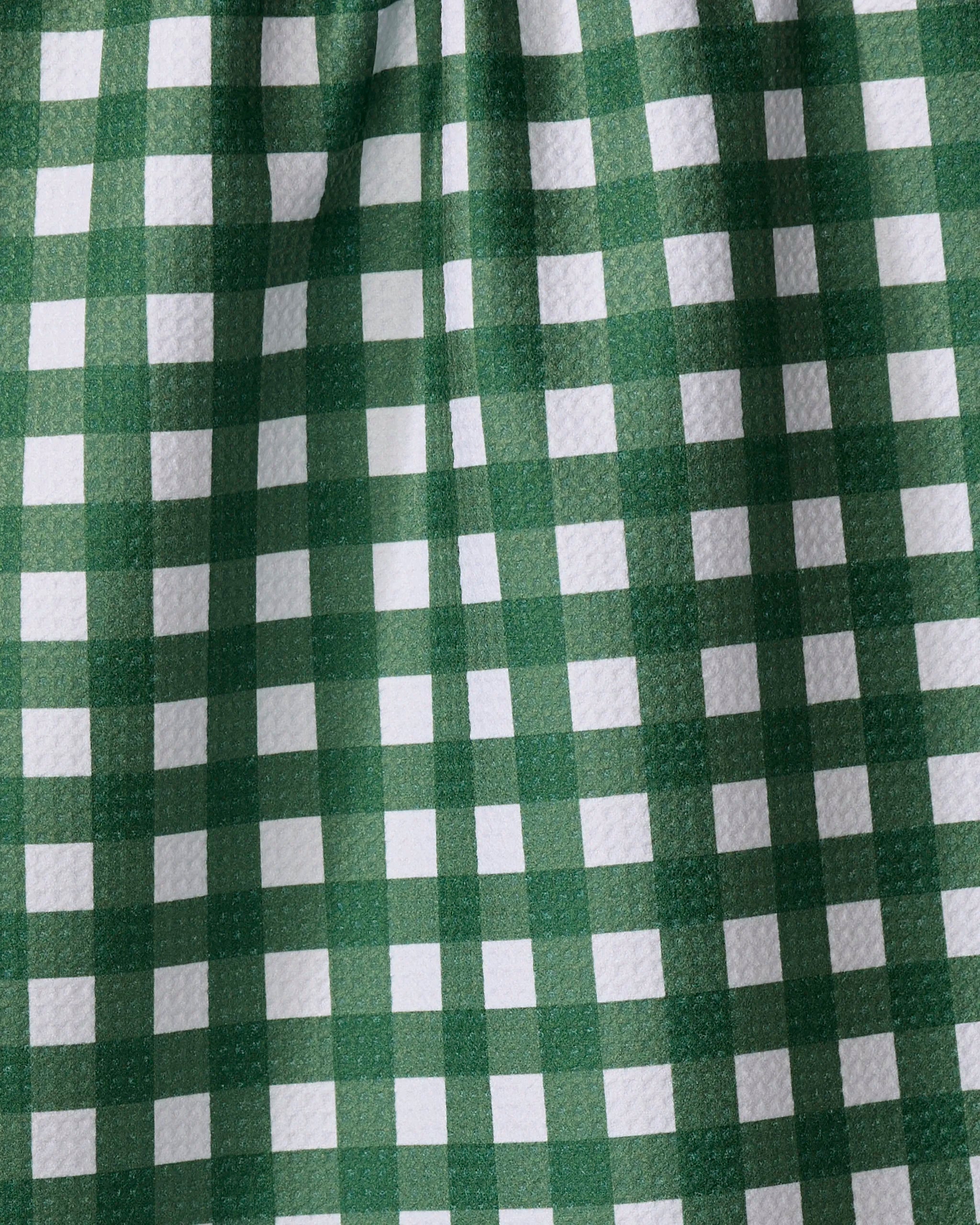 Gigi - Evergreen by The Buy Guide features green and white gingham fabric with a checkered tea towel pattern, subtle folds, and a textured surface.