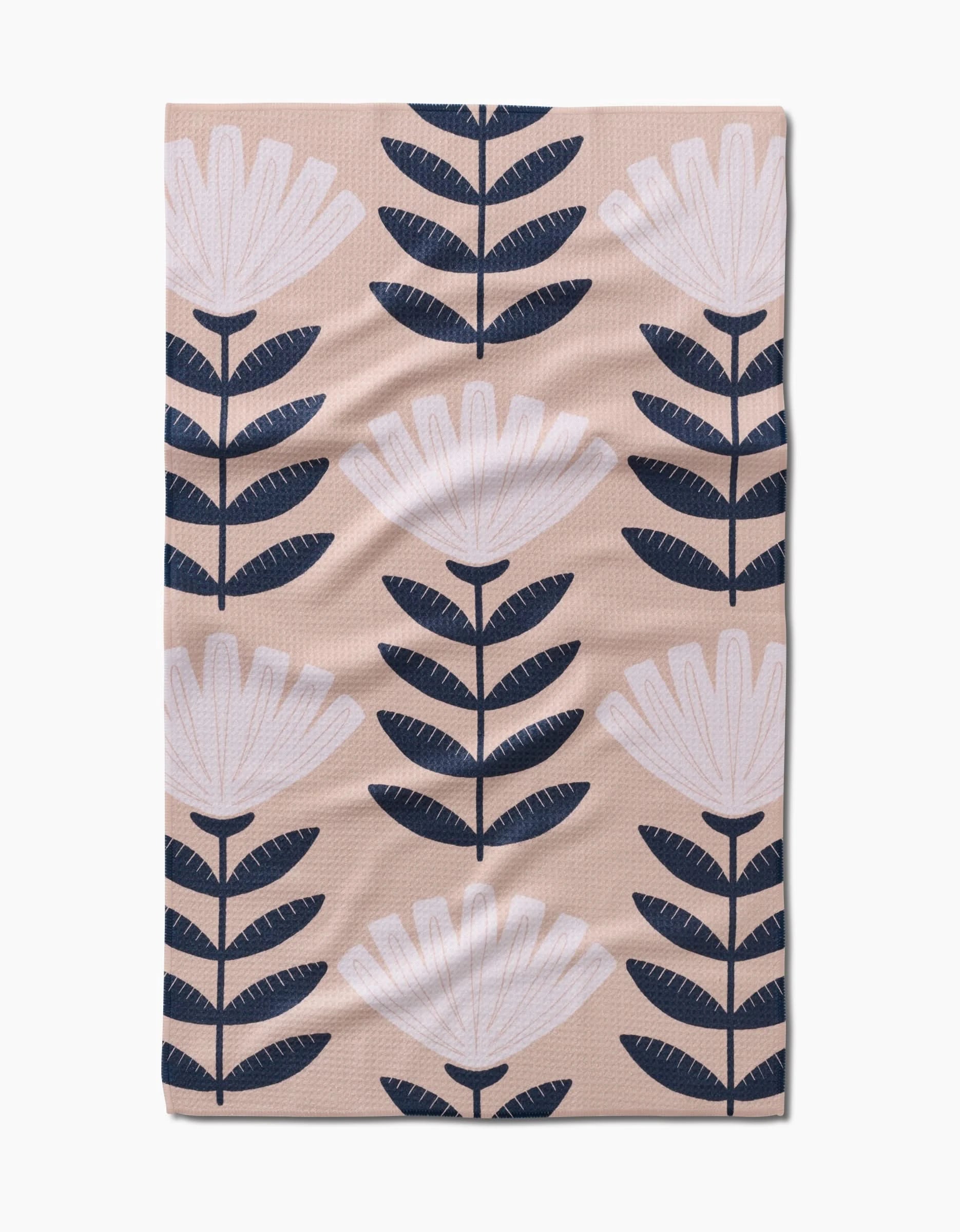 The Gloria rectangular Geoweave fabric cloth by Amy MacCready features white stylized flowers and dark blue leaves in vertical rows on a beige background.