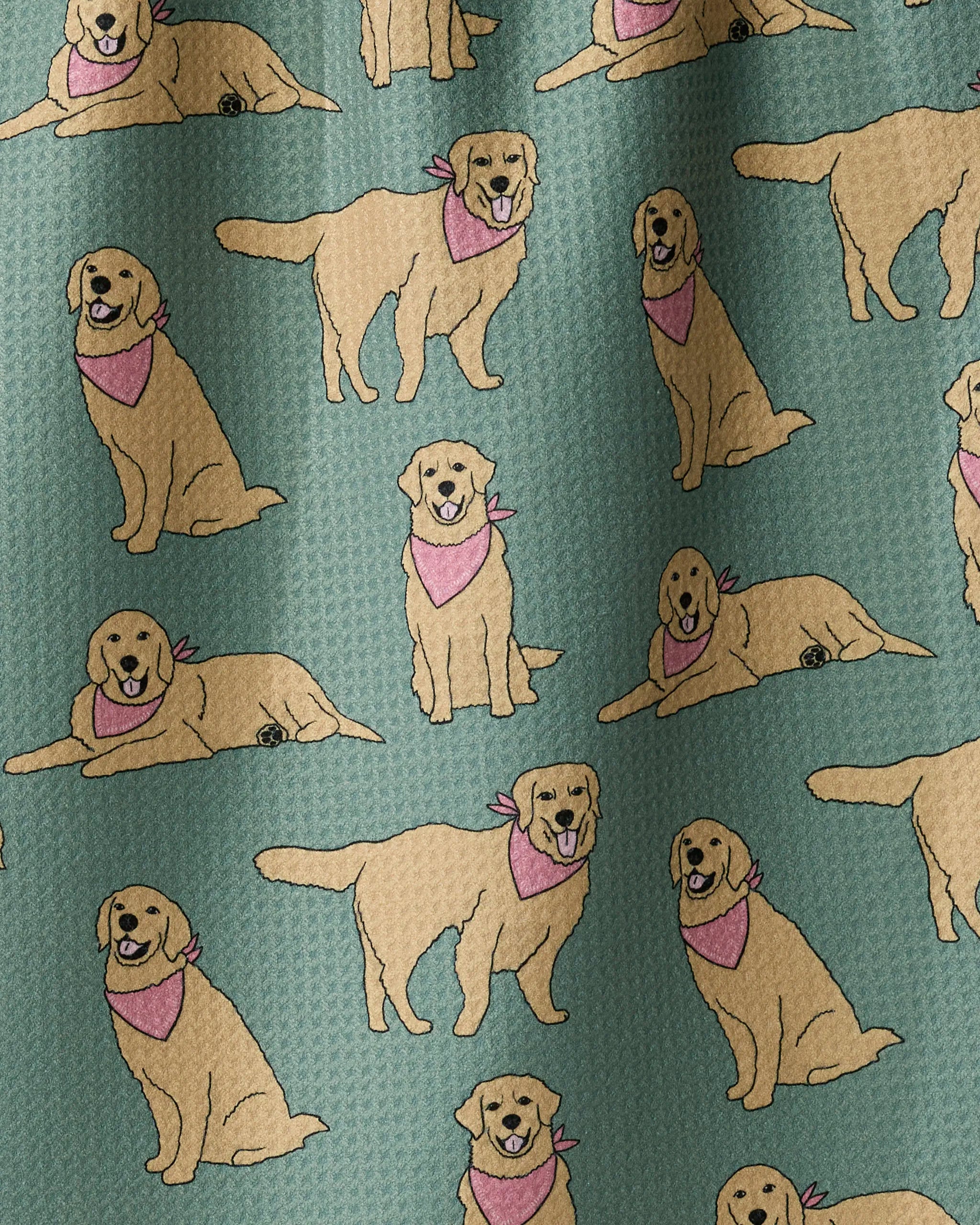 Introducing Golden Days by Geometry: a patterned fabric made from recycled materials, featuring playful illustrations of golden retrievers in pink bandanas—sitting, lying, and standing—set against a teal background. The perfect choice for adding charm to your kitchen tea towel collection.