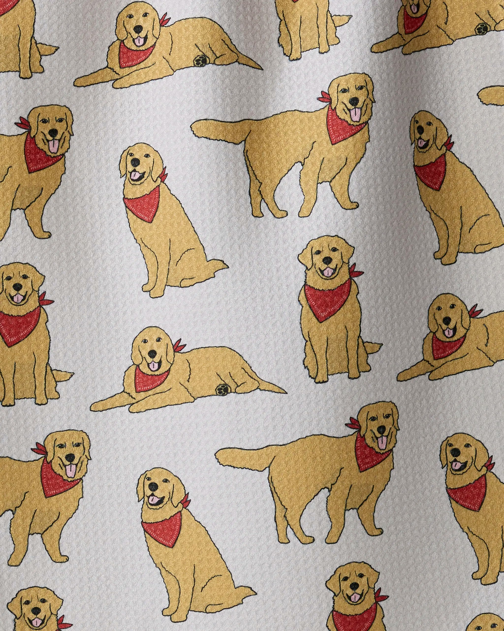 Golden Days by Geometry features a delightful pattern of cartoon golden retriever dogs in playful sitting, standing, and lying poses, each wearing a red bandana on a textured white background. This charming kitchen tea towel is made from recycled materials and is designed to be ultra-absorbent for everyday use.