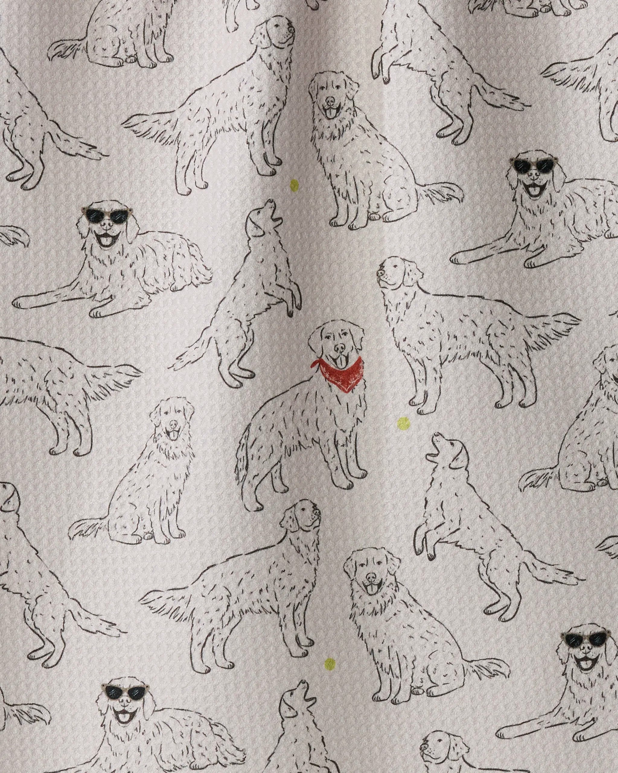 Golden Gang by Geometry features a playful pattern of sketched golden retrievers in various poses on a crisp white background—some sporting sunglasses, one with a red bandana, and cheerful yellow dots scattered throughout. This charming design makes the perfect eco-friendly tea towel to add personality and fun to any kitchen.