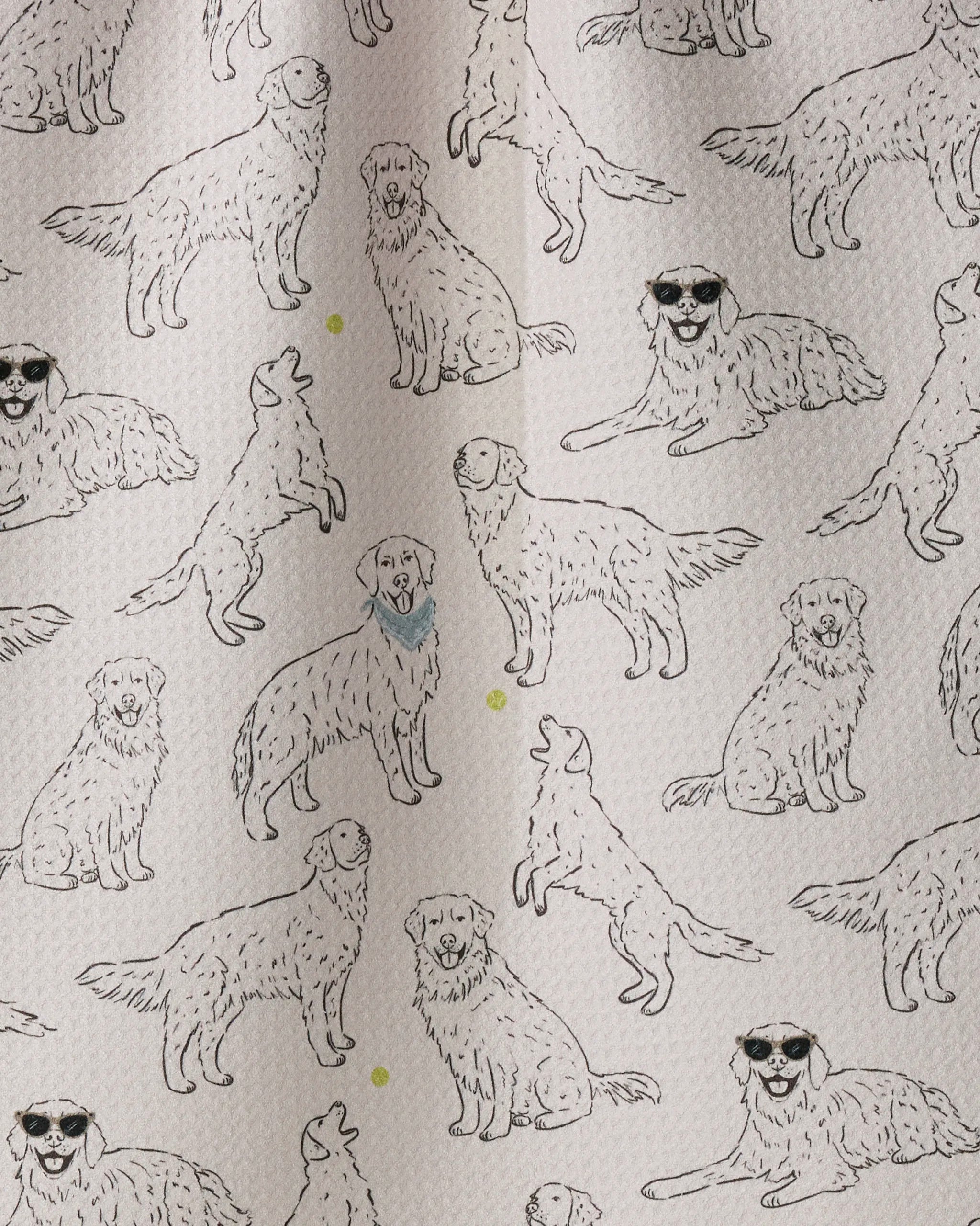 The Geometry “Golden Gang” kitchen towel features a charming patterned fabric with line drawings of dogs in various poses—some sporting sunglasses or a blue scarf—set against a light background accented with small yellow dots.