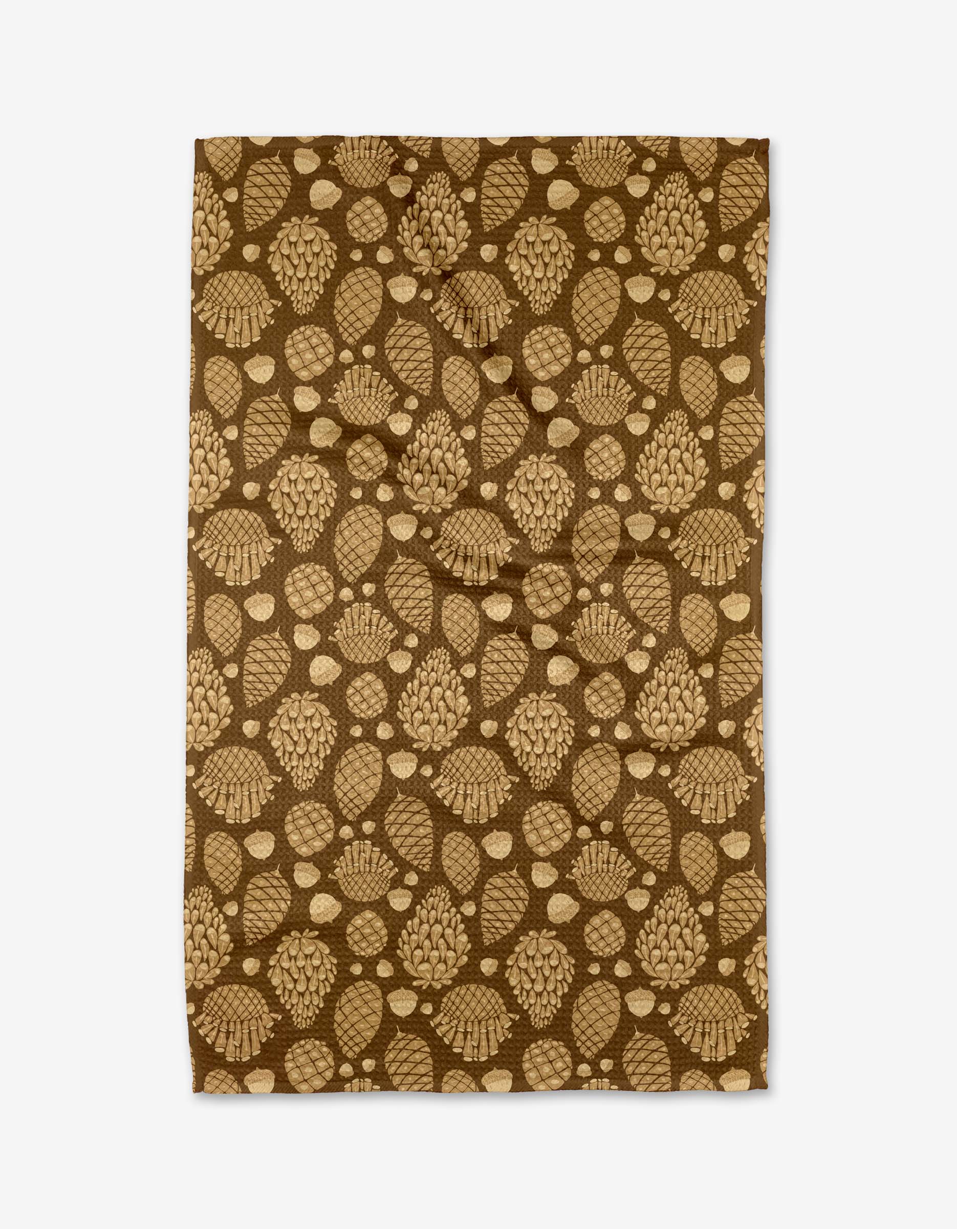 The Golden Pines rug by Danelys Sidron is a rectangular brown piece made from recycled materials, featuring tan pinecones, acorns, and leaves scattered across its surface.
