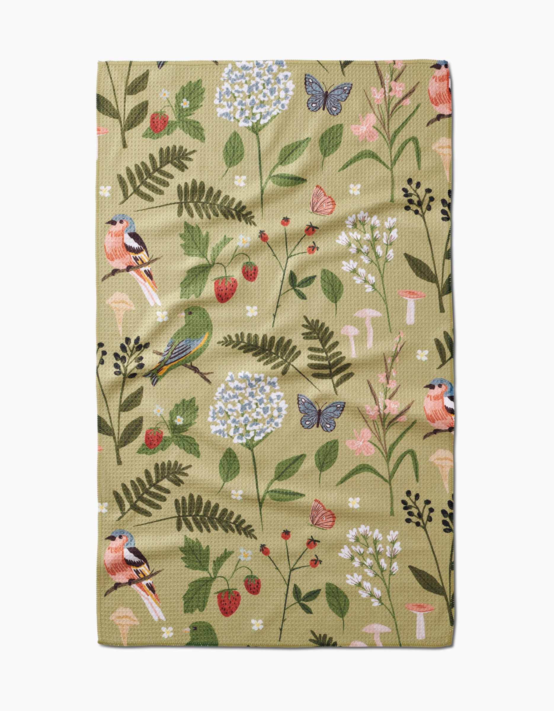 The Good Green Earth tea towel by Janna Sue Design is made from recycled materials and features an illustrated nature pattern with birds, butterflies, flowers, strawberries, mushrooms, and green leaves on a light olive Geoweave™ fabric.