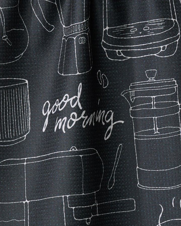 The Rosa Kichline Good Morning Coffee tea towel features black fabric with white line drawings of coffee makers, a grinder, and utensils, plus "Good morning" in cursive—an eco-friendly, quick-drying way to brighten your kitchen.