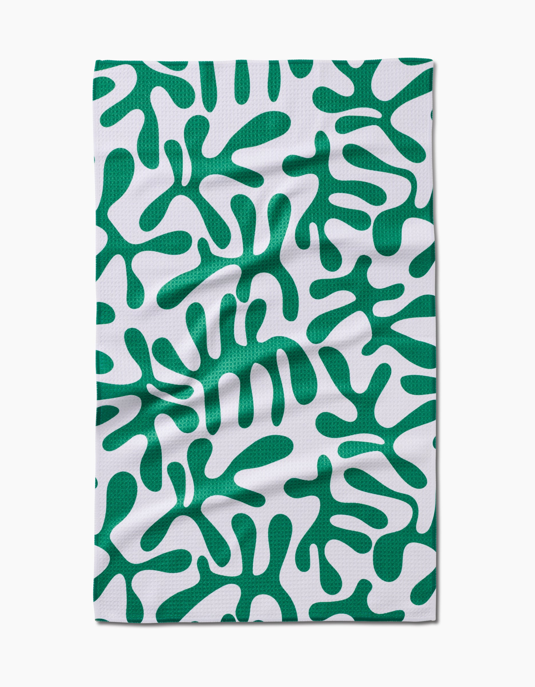 Green Afternoon by Marina Solodka is a rectangular white Geoweave cloth with an abstract green amoeba-like pattern on its ultra-absorbent, eco-friendly surface. Slight wrinkles may be visible on the fabric.